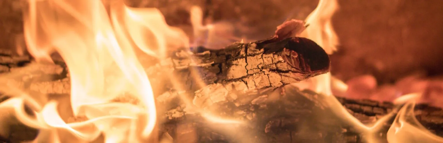 Split firewood beside a wood stove